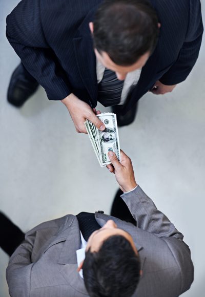 Two businessmen exchanging cash
